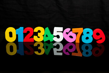 back to school concept of numbers colorful wood pieces on black background