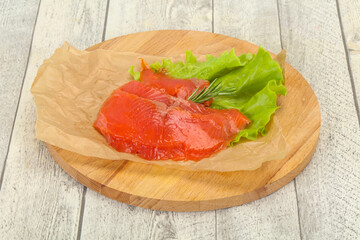 Sliced salmon fillet served rosemary