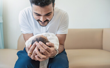 Closeup portrait of young asian Indian father holding his newborn baby with copy space. Healthcare...