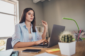 Photo of thoughtful cute girl sit desk work netbook spectacles mouth wear shirt in home office...