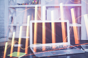 Obraz na płótnie Canvas Stock market graph on background with desk and personal computer. Multi exposure. Concept of financial analysis.