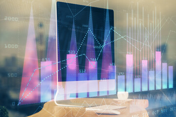 Financial market graph hologram and personal computer on background. Multi exposure. Concept of forex.