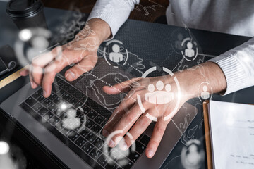 Man using computer. Hands typing laptop. Double exposure with social network hologram. Close up. Media concept.