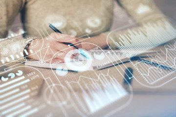 Technology theme hologram over woman's hands taking notes background. Concept of Tech. Double...