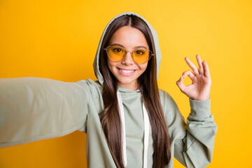 Photo of beautiful face brunette show finger okey symbol lifestyle stylish hoodie isolated on...