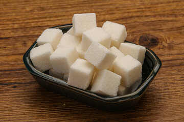Refined white sugar cubs in the bowl