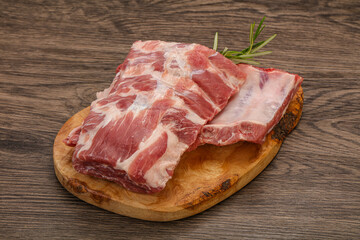 Raw pork ribs served rosemary