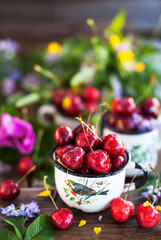 Fresh ripe cherries in a mug on summer background