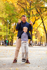 Fototapeta premium Blonde little boy in autumn park