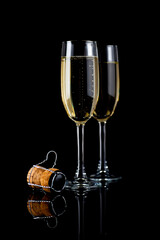Studio photo of a champagne glasses with champagne cork on black background.
