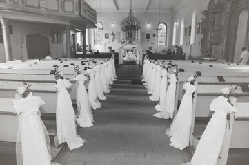 Church sanctuary before a wedding ceremony. Empty chairs for bride and groom.