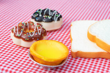 Obraz na płótnie Canvas Donut dessert and egg tart with bread on on red tablecloth