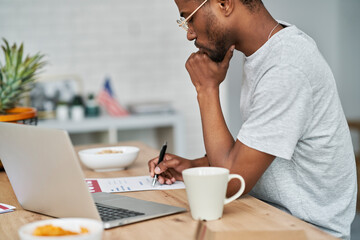 Side view of black man voting from home