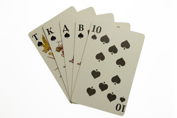 Five playing cards fanned out in the center of the frame on a white clipping background
