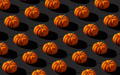 Halloween background. Pumpkin pattern on black background.