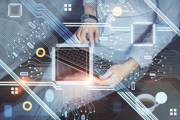 Multi exposure of data internet theme hologram with man working on computer on background. Concept of innovation.