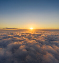 Fototapeta na wymiar Beautiful sunrais cloudy sky from aerial view. Airplane view above clouds