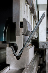Bending sheet metal on a hydraulic machine at the factory. Bend tools, press brake punch and die....