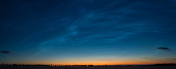 Panorama of sky with noctilucent near Prague