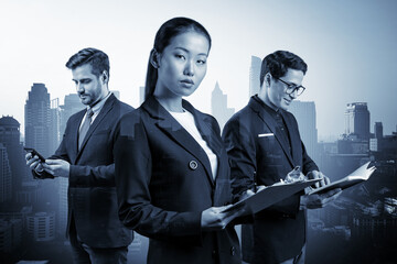 Group of three business colleagues in suits working on project together to gain new career...