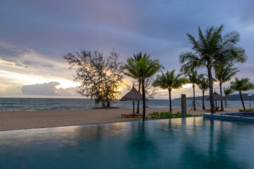 Beautiful sunset on the swimming pool with seaview