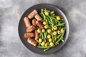 Bean pods, olive and fried Turkish meatball.