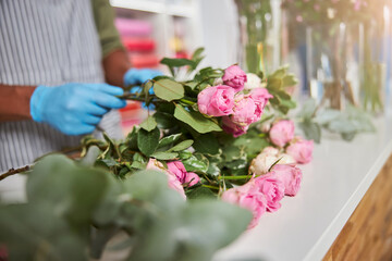 Florist with blooming roses during working day