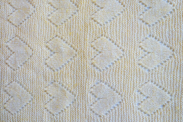 Piece of mint knitted as a background, yellow color, top view
