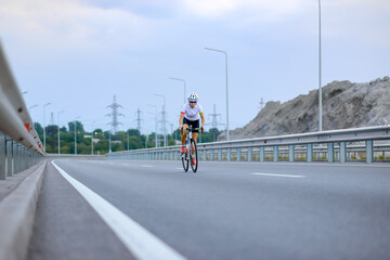 Young Woman Cyclist Riding Bike on the Mountain Road. Adventure, Healthy Lifestyle, Sport