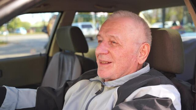Caucasian elderly man using car, active happy retirement. Traveling alone on pension 