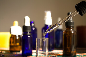 focus on the drop from the pipette into the central vial