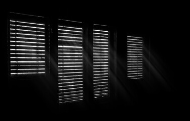 Beams of sunlight through old wooden blinds. Light coming through windows of an old abandoned...