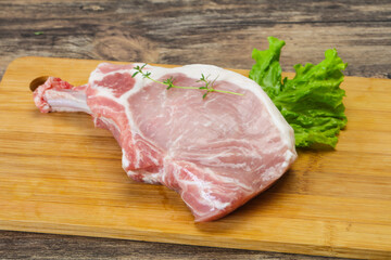 Raw pork bone steak over wooden