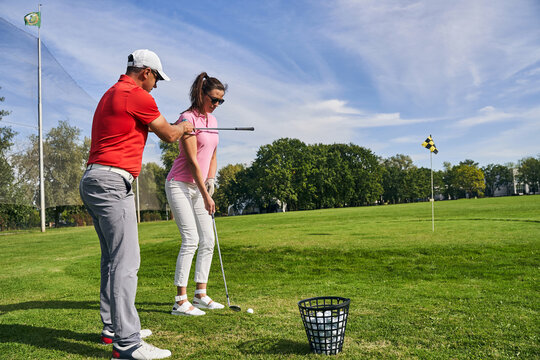 Trainer aligning the shoulders of his student beginner