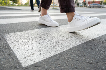 female feet crossing the crosswalk
