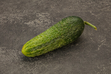 Green ripe fresh cucumber over background