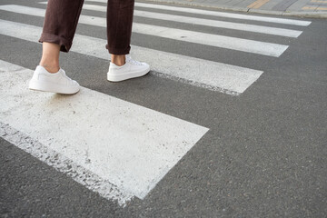 female feet crossing the crosswalk

