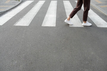 female feet crossing the crosswalk