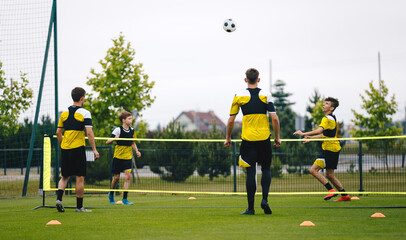 Youth teenage football players playing football tennis on training unit. Teenagers practicing...