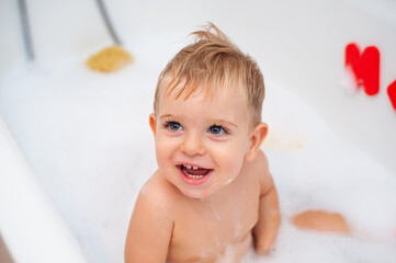 baby in bathtub with foam