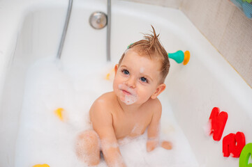 baby in bathtub with foam
