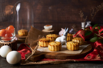 Mooncake a Chinese traditional pastry for Mid-Autumn festival. set on rustic wooden table.