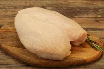 Raw whole chicken breast with skin