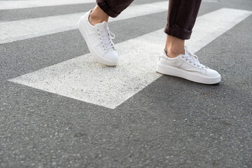 female feet crossing the crosswalk
