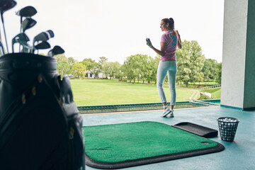 Pleased golfer with a club over her shoulder