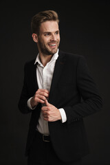 Happy confident unshaven businessman posing and smiling