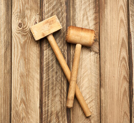 wooden kitchen hammer on a background of gray boards