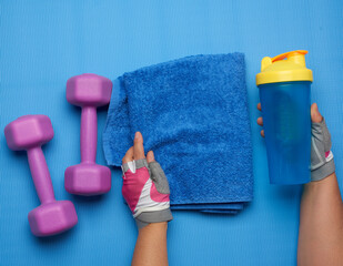 pair of dumbbells and blue towel