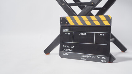 Naklejka premium Director chair with black and yellow clapper board or movie slate on white background.it is used in video production and film industry.