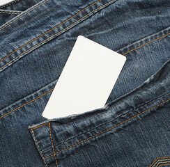 empty white paper card is in the back pocket of blue jeans